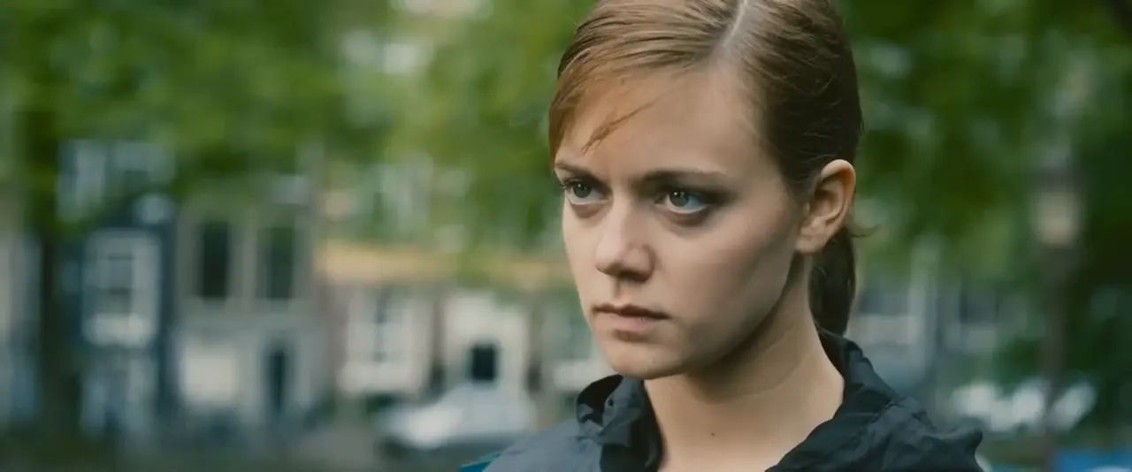 A close-up of Celia, right of centre. A yellow box marks her face; the red 9:16 crop and the green 4:5 crop both hold it.